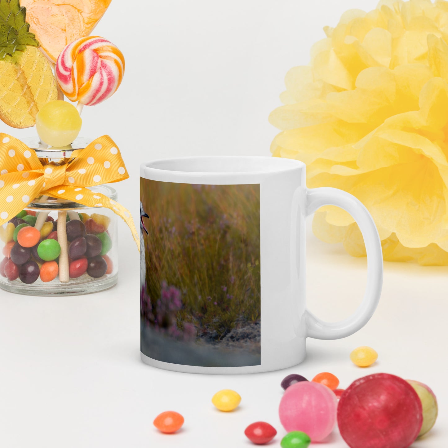 White mug with a picture of a young common gull surrounded by pink flowers